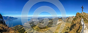 Young woman hiker with backpack on a mountain top against sky background. Travel concept