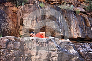 Young woman hiker and bat in Hance Creek in the Grand Canyon.