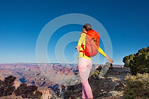 Young woman hiker on the edge of Grand canyon