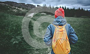 Young woman hiker hiking in beautiful mountains