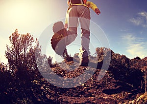 Young woman hiker hiking on mountain peak