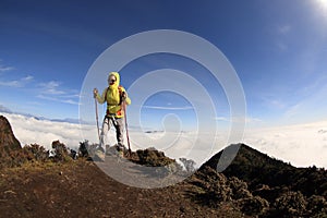 Young woman hiker hiking on mountain peak