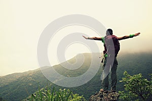 Young woman hiker open arms outdoor