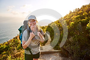 Young woman hiker smiling on a picturesque nature trail