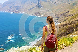 Young woman hiker standing admiring Tenerife Island landscape in a healthy active lifestyle concept