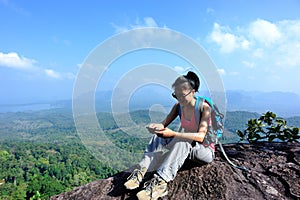 Young woman hiker using smartphone