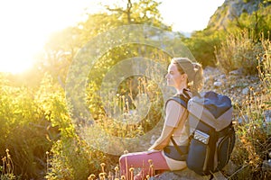 Young woman hiking in countryside. Backpacking hike