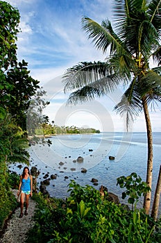 Young woman hiking Lavena Costal Walk on Taveuni Island, Fiji