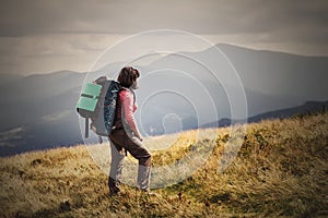 Young woman hiking on mountains with backpack Travel Lifestyle a