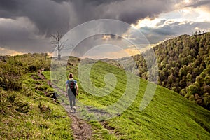 Young woman hiking in the mountains of the French Basque Country with her dogs