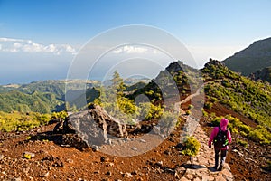 Young woman hiking on path to Pico Ruivo, highest peak of Madeira island, Portugal photo