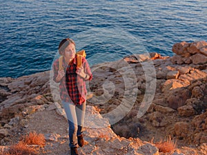 Young woman hiking on rocky beach in Spain, Benidorm