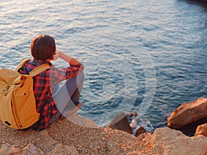 Young woman hiking on rocky beach in Spain, Benidorm