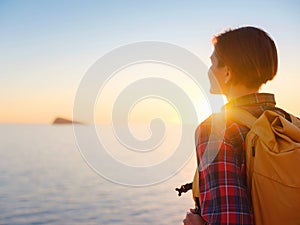 Young woman hiking on rocky beach in Spain, Benidorm