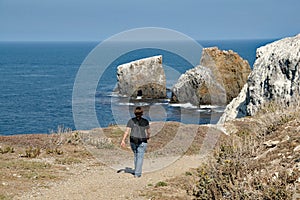 Young woman on hiking trail in East Anacapa Island in Channel Islands National Park, California.