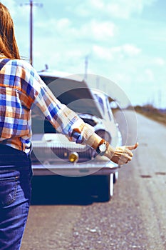 Young woman hitch-hiking