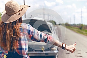 Young woman hitch-hiking