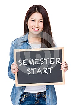 Young woman hold with chalkboard showing phrase of semester star