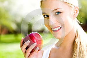 Young woman holding apple