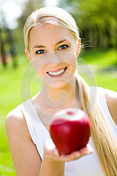 Young woman holding apple