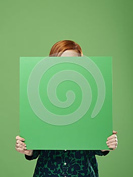 Young woman holding banner with copy space in studio shot