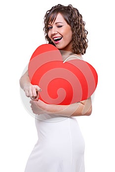 Young woman holding big red heart
