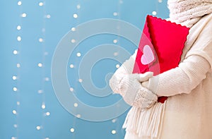 Young woman holding a big Valentine`s day envelope