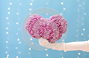 Young woman holding a big Valentine`s day heart