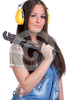 Young woman holding big wrench