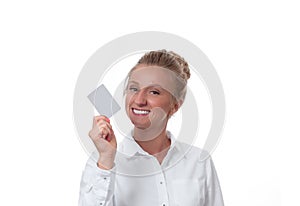 Young woman holding blank business card with copy space