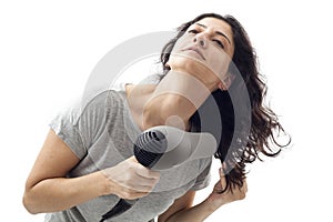 Young woman holding blow dryer