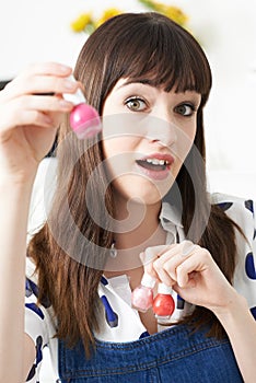 Young Woman Holding Bottles Of Colorful Nail Polish