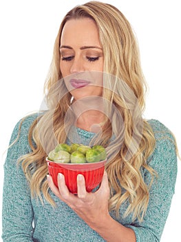 Young Woman Holding a Bowl of Brussels Sprouts