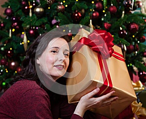 Young woman holding a box with a New Year gift