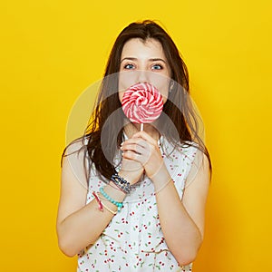 Young woman holding bright candy