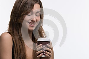 Young woman holding brown cup of coffee