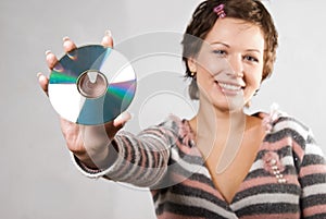 Young woman holding CD disk