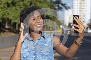 Young woman holding a cellphone to make video call