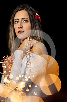Young woman holding Christmas's string lights