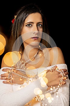 Young woman holding Christmas's string lights