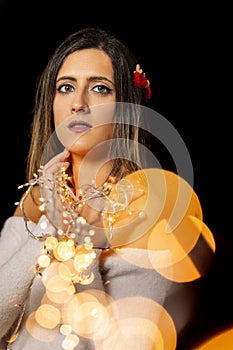 Young woman holding Christmas's string lights