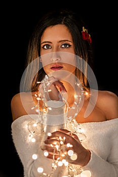 Young woman holding Christmas's string lights