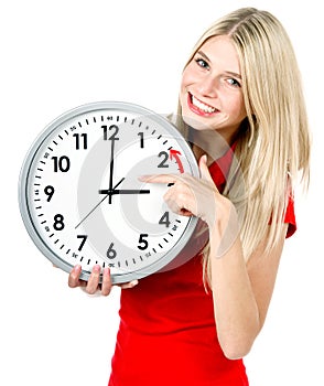 Young woman holding a clock. winter time