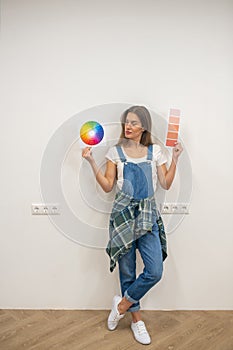 Young woman holding a color palette in hands