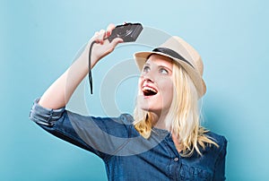 Young woman holding a compact camera