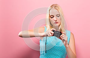 Young woman holding a compact camera