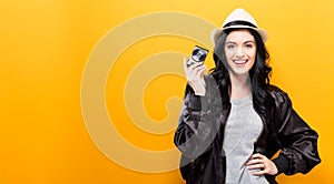 Young woman holding a compact camera