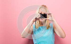 Young woman holding a compact camera