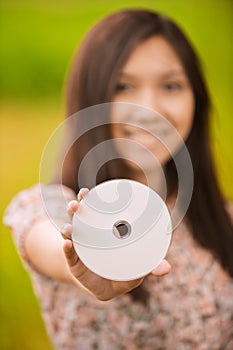 Young woman holding compact-disk