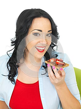 Young Woman Holding a Cracker with Chocolate Spread and Fresh Ripe Strawberries